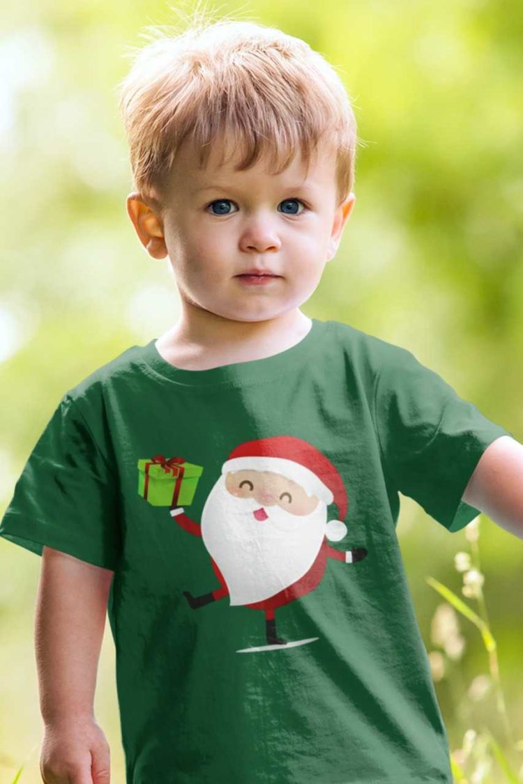 cute boy in a green tshirt with Santa holding a gift