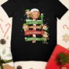 black tshirt with elves on a north pole signpost