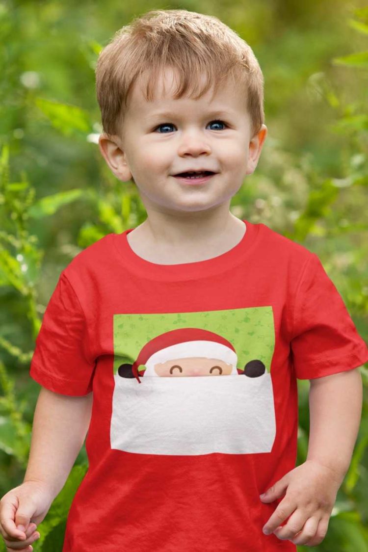 cute boy in a red tshirt with Santa peeping out