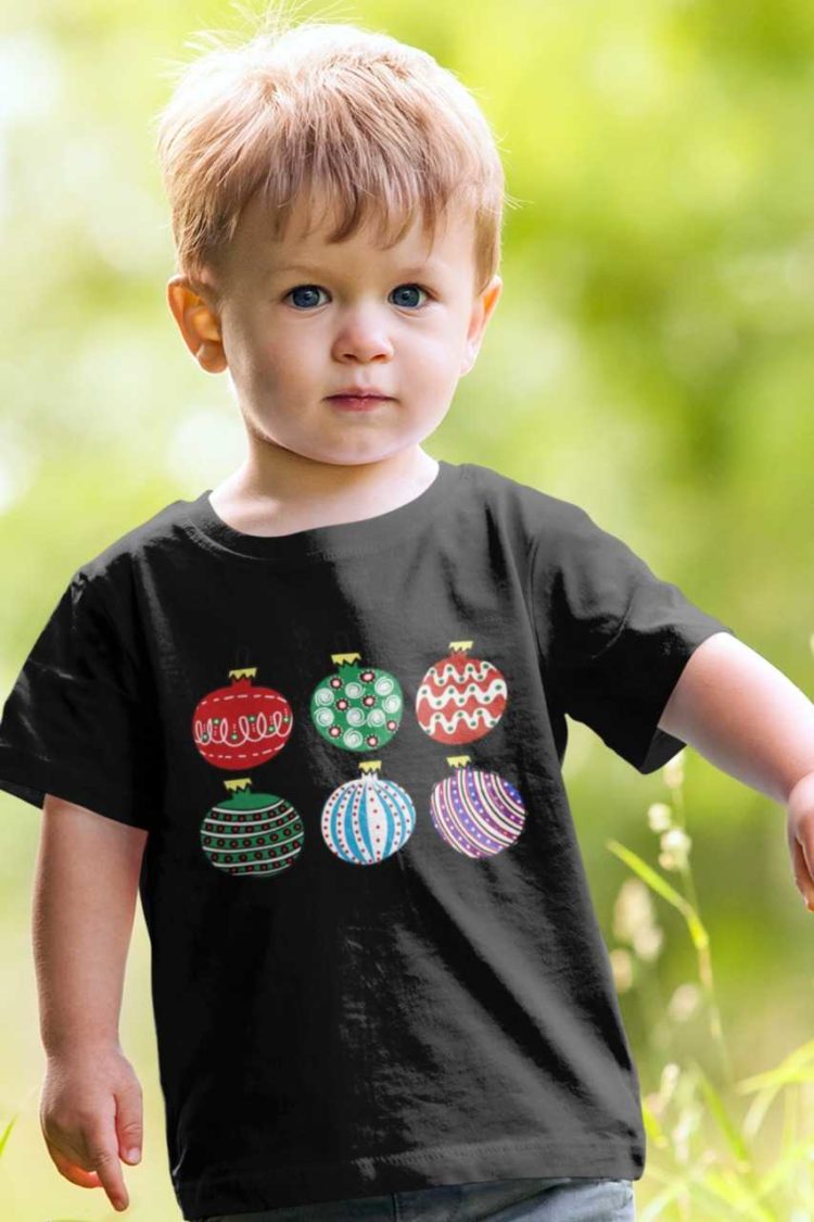 Cute boy in a black tshirt with Christmas ornaments