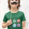 playful boy in a green tshirt with Christmas ornaments