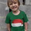 happy little boy in a green tshirt with Santa Hat