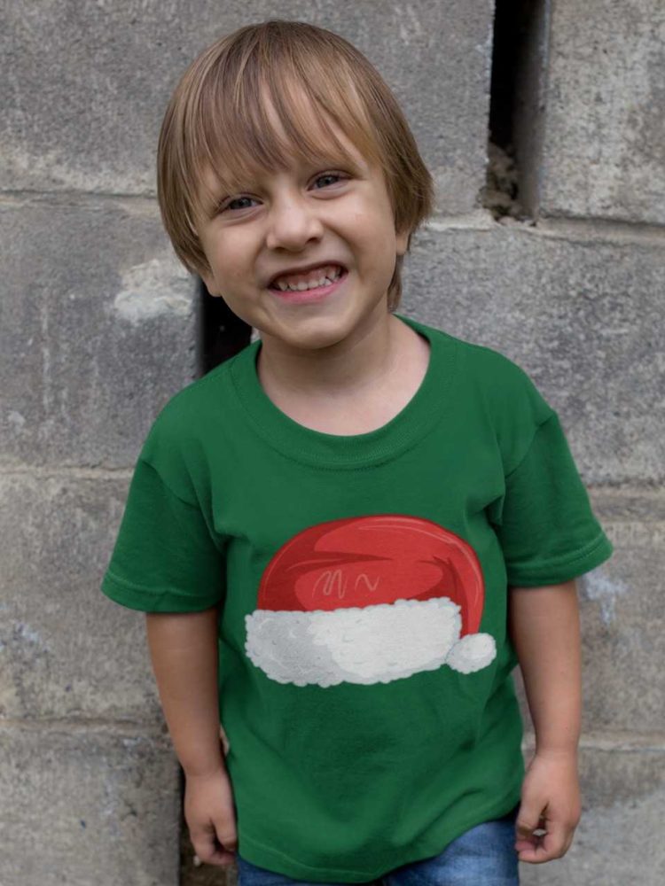 happy little boy in a green tshirt with Santa Hat