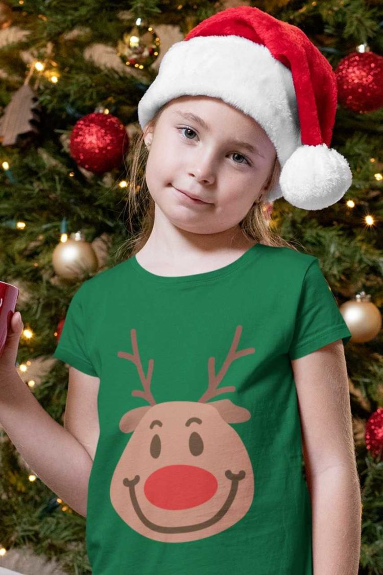 girl in a santa hat wearing a Green tshirt with a Smiling reindeer face