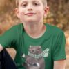 Smart boy in a green tshirt with a Bear holding christmas lights