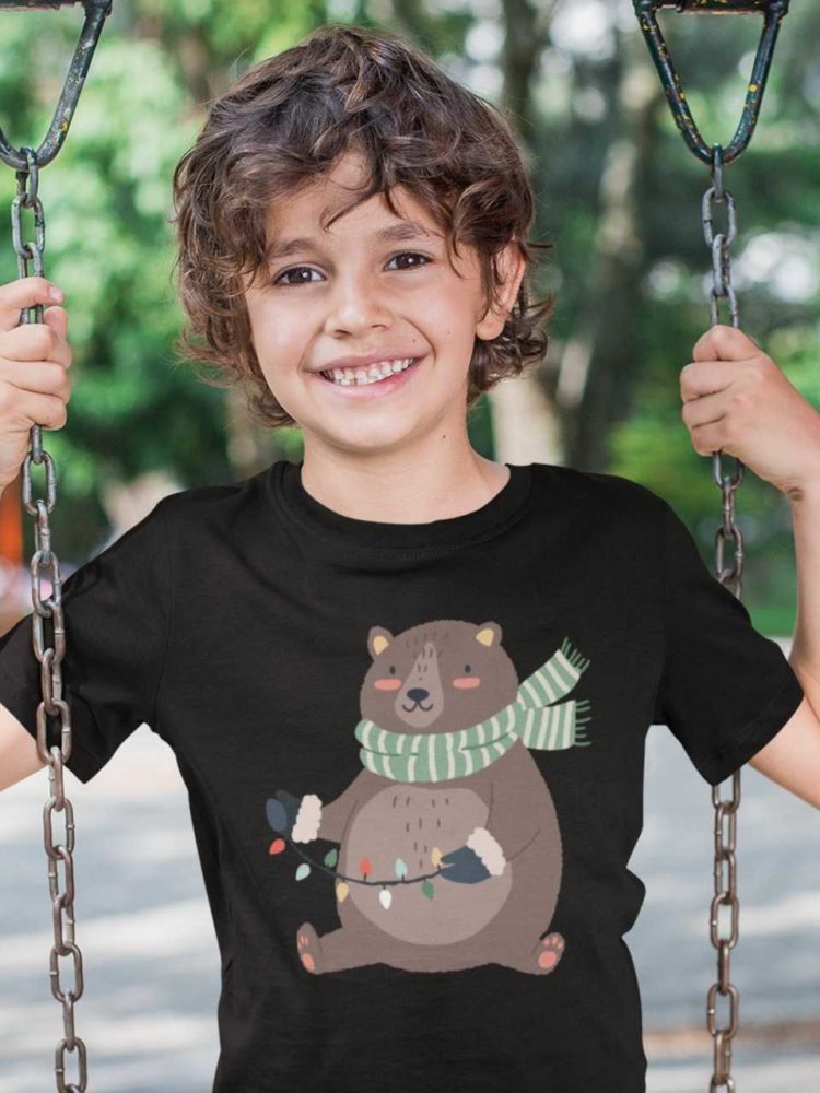 cool boy in a black tshirt with a Bear holding christmas lights