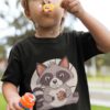 little boy blowing bubbles ina black tshirt with a cute raccoon eating a cookie