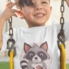 little boy on a swing ina white tshirt with a cute raccoon eating a cookie