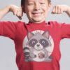 playful little boy in a red tshirt with a Cute Raccoon eating a cookie