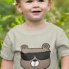 Cute boy in a grey Tshirt with a bear wearing sunglasses
