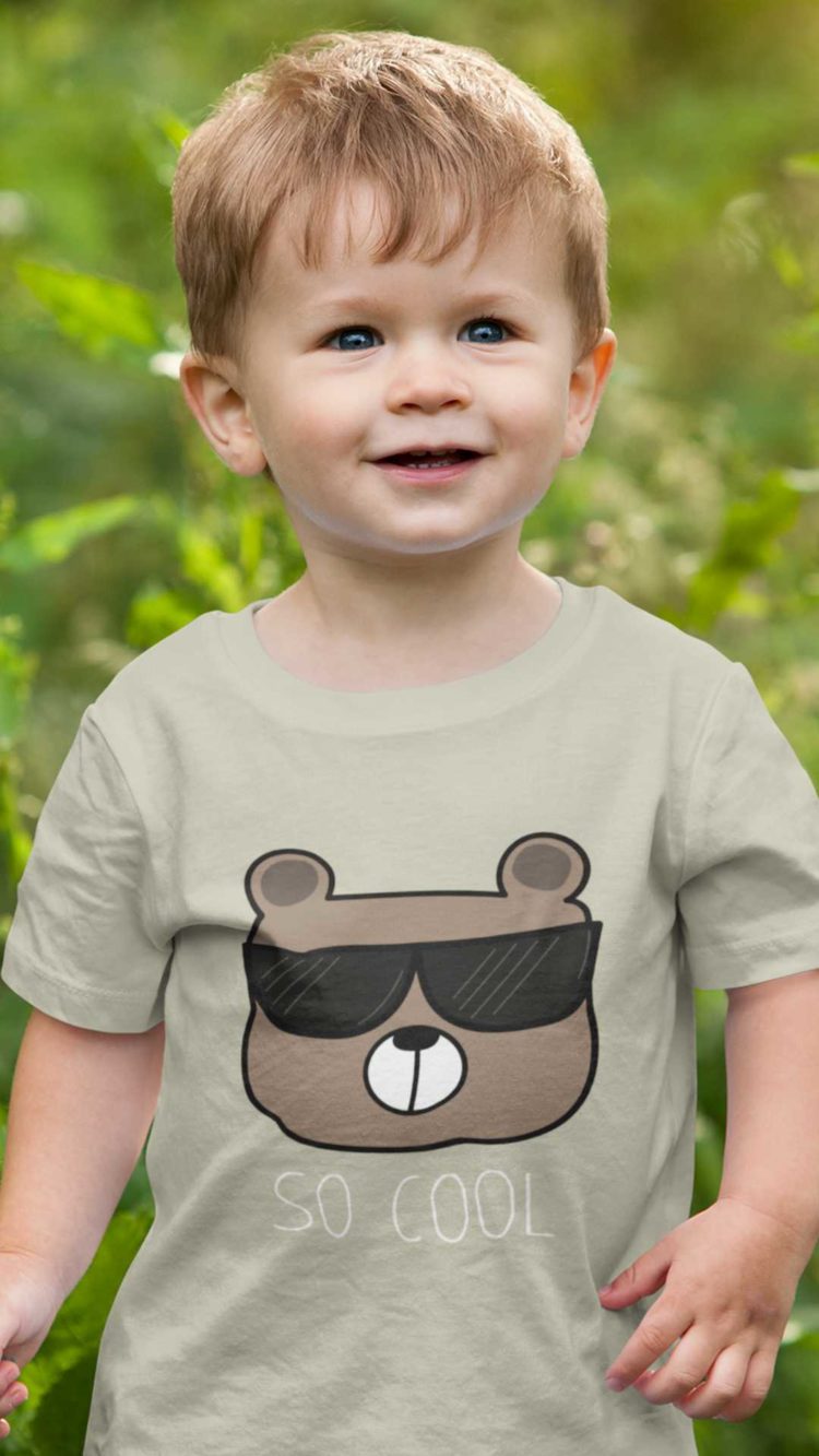 Cute boy in a grey Tshirt with a bear wearing sunglasses