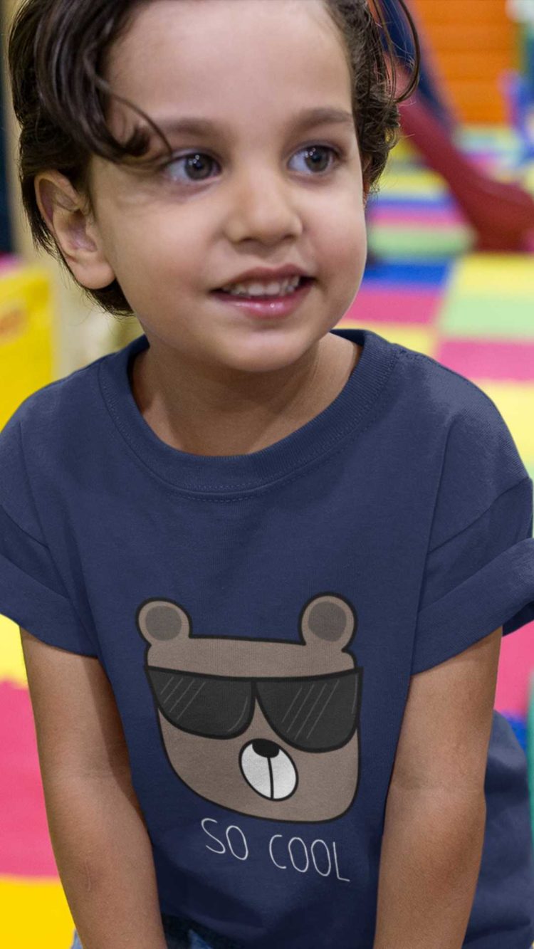 sweet little boy in a navy blue Tshirt with a bear wearing sunglasses