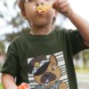 little boy blowing bubbles with a Police dog on an olive green tshirt