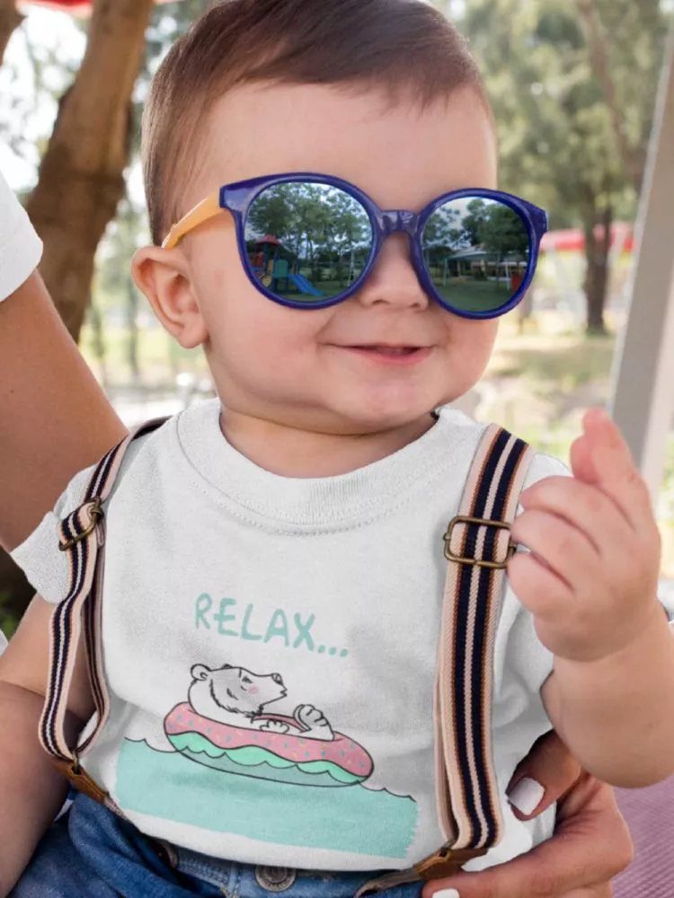 Adorable Little Boy Wearing A White Tshirt With A Bear Relaxing
