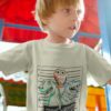 Little Boy In a Grey Tshirt With Dinos Mugshot