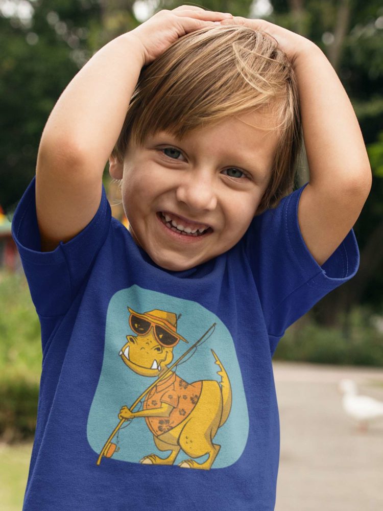 playful boy in a deep blue tshirt with Dinosaur holding a fishing rod