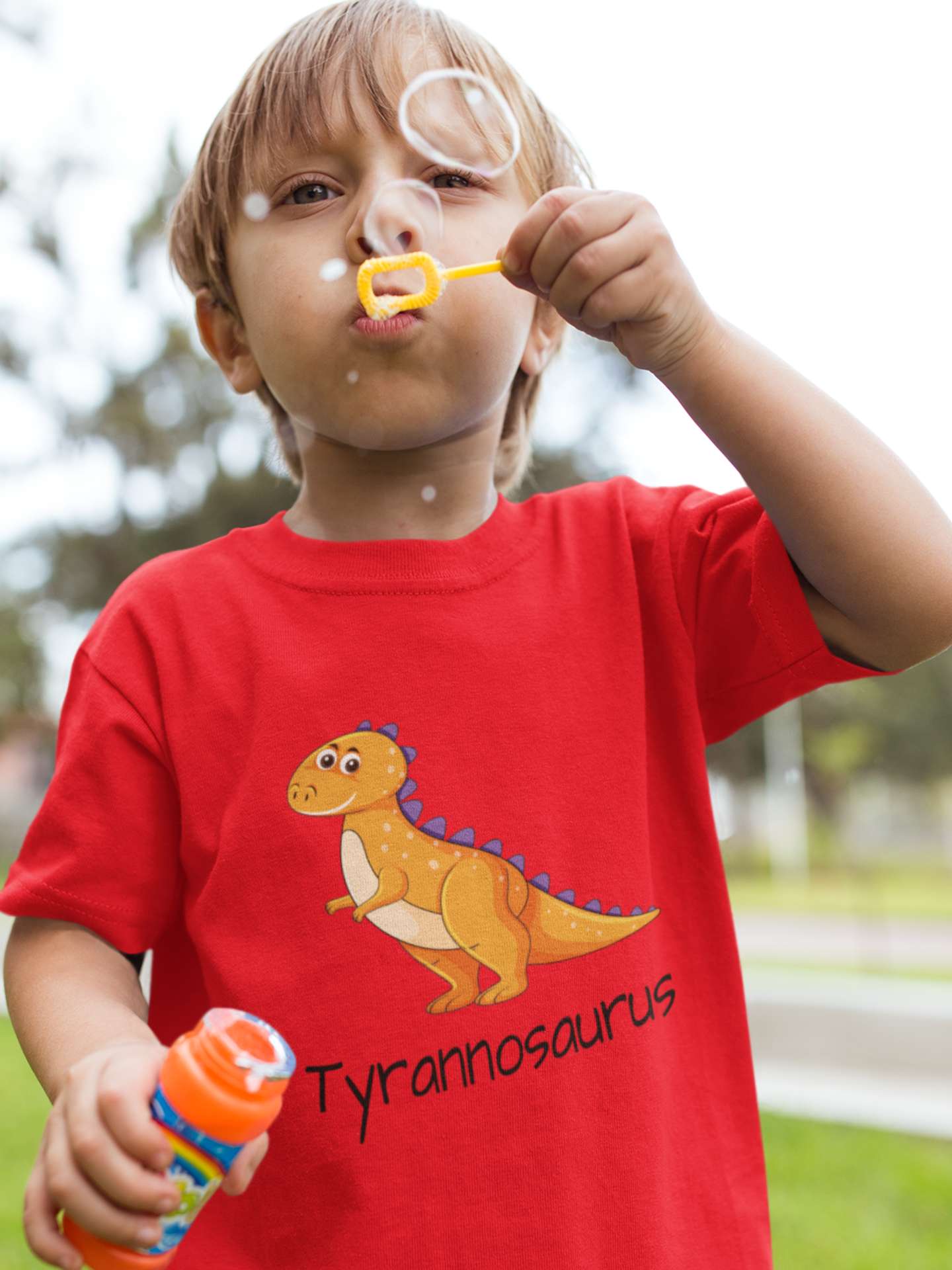 playful little boy in a red tyrannosaurus tshirt